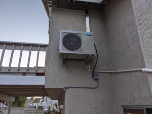Daikin AC outdoor unit mounted on the wall outdoor.
